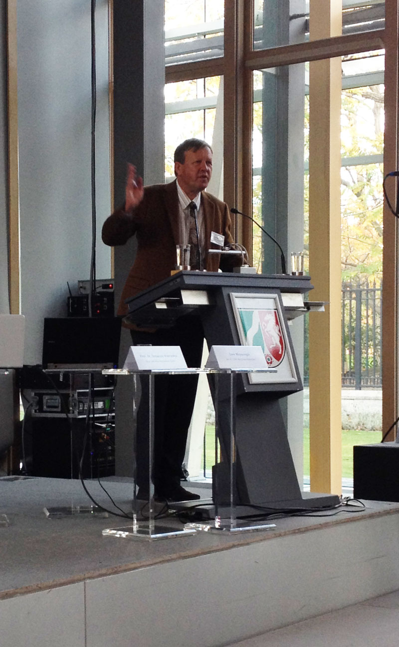 Mann hält Vortrag an einem Rednerpult.