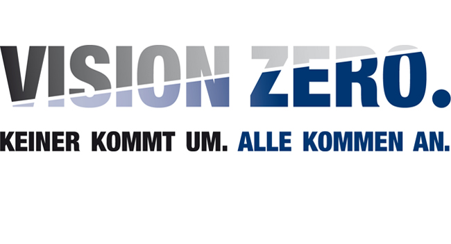 Das Bild zeigt das Logo mit dem Slogan 'VISION ZERO. KEINER KOMMT UM. ALLE KOMMEN AN.'. Dieses Motto steht für ein Arbeitsschutz- und Präventionskonzept, das darauf abzielt, Arbeitsunfälle und Gesundheitsrisiken komplett zu vermeiden. Das Logo verwendet große Blockbuchstaben und einen stufenweisen Farbverlauf von grau zu blau in 'Vision Zero'.