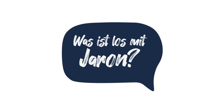Die Grafik zeigt eine dunkelblaue Sprechblase mit dem handgeschriebenen weißen Text 'Was ist los mit Jaron?'. Dies kann auf eine Kampagne oder ein Projekt hinweisen, möglicherweise im Kontext von Arbeitsschutz oder Prävention, um Aufmerksamkeit auf ein bestimmtes Thema im Zusammenhang mit der Unfallkasse NRW zu lenken.